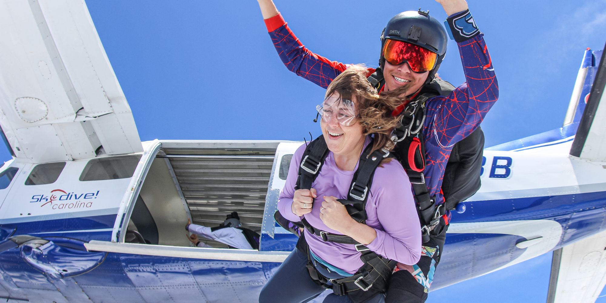 Male and female tandem passenger exit the airplane at Skydive Carolina!