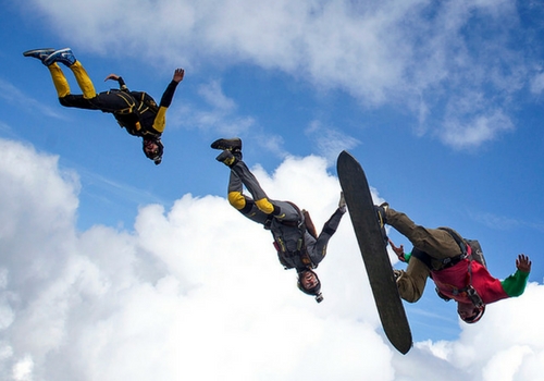 skydiver sky surfing with experienced jumpers